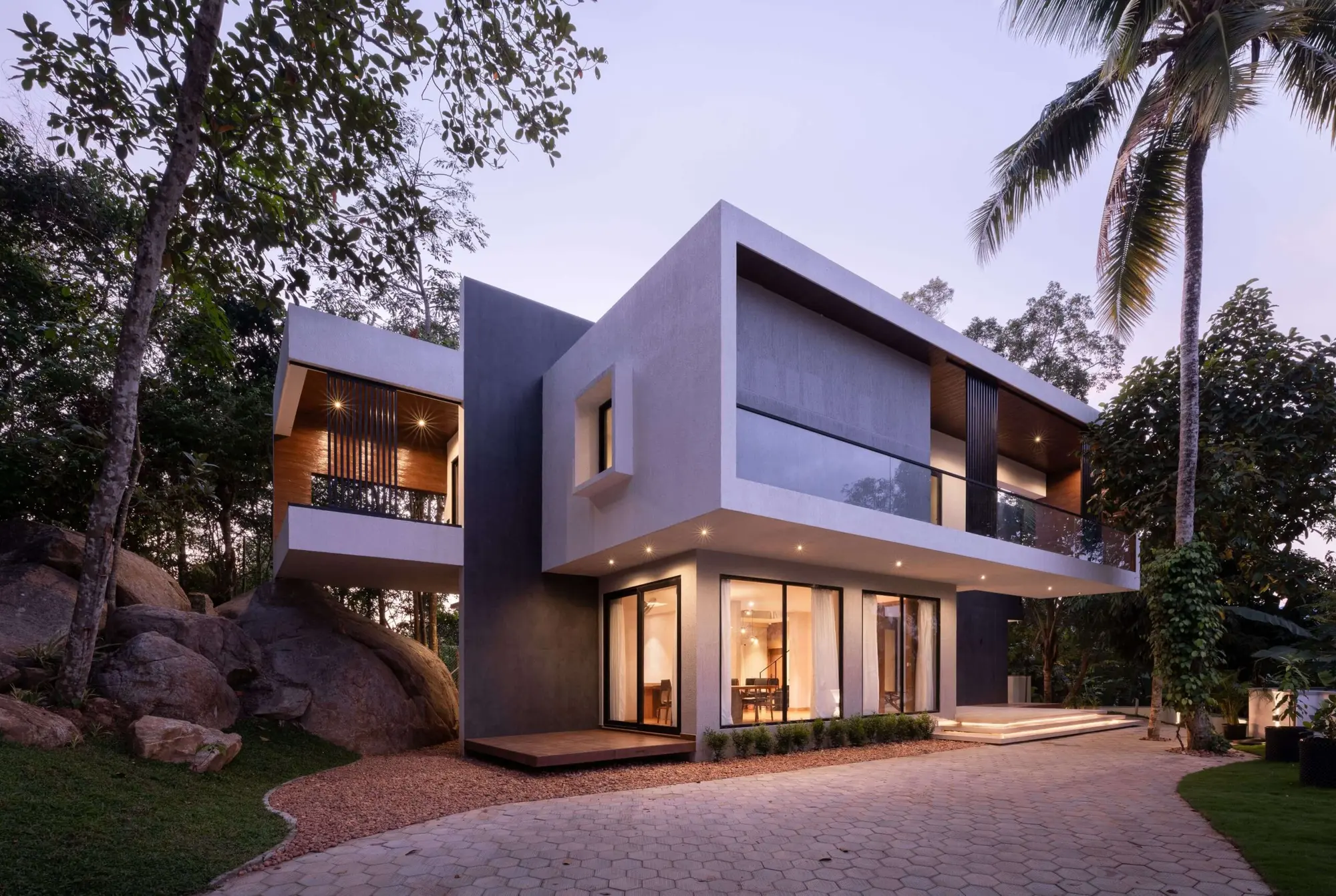 House on the Rock residence in Trivandrum among mature trees and natural rock