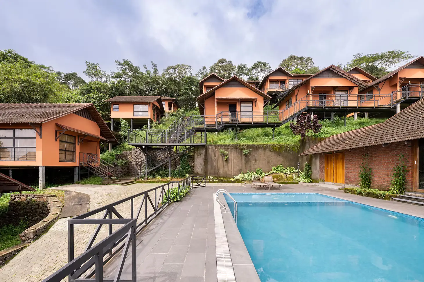 Infinity pool and hillside villas in daylight